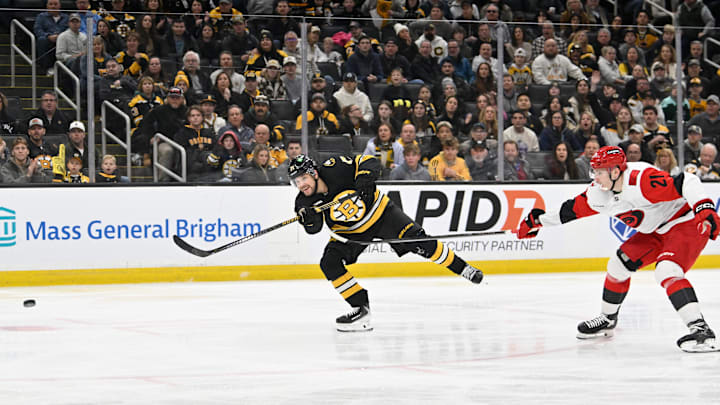 Nov 1, 2025; Boston, Massachusetts, USA; Boston Bruins left wing Viktor Arvidsson (71) scores a goal with pressure from Carolina Hurricanes defenseman Alexander Nikishin (21) during the third period at TD Garden. Mandatory Credit: Eric Canha-Imagn Images