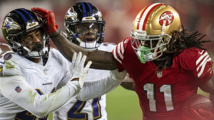 Dec 25, 2023; Santa Clara, California, USA; San Francisco 49ers wide receiver Brandon Aiyuk (11) rushes for the first down against Baltimore Ravens safety Geno Stone (26) during the fourth quarter at Levi's Stadium. Mandatory Credit: Neville E. Guard-USA TODAY Sports
