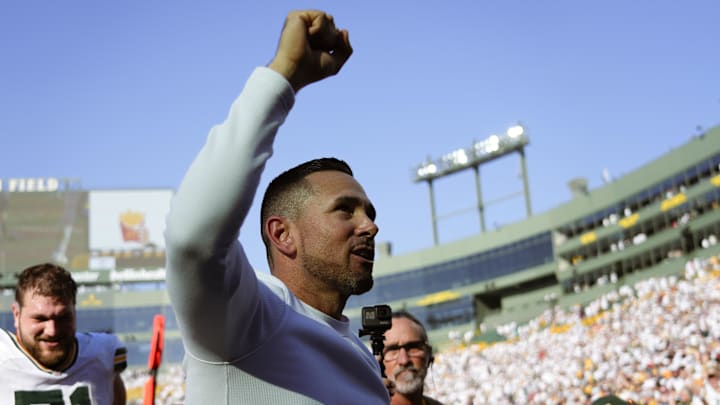 Oct 20, 2024; Green Bay, Wisconsin, USA;  Green Bay Packers head coach Matt LaFleur celebrates while walking off the field following the game against the Houston Texans at Lambeau Field. Mandatory Credit: Jeff Hanisch-Imagn Images