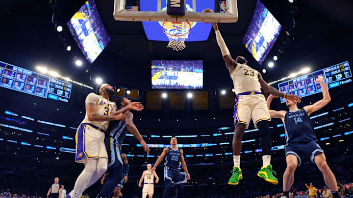 Dec 15, 2024; Los Angeles, California, USA; Los Angeles Lakers forward LeBron James (23) shoots the ball against Memphis Grizzlies center Zach Edey (14) in the second half at Crypto.com Arena. Mandatory Credit: Kirby Lee-Imagn Images