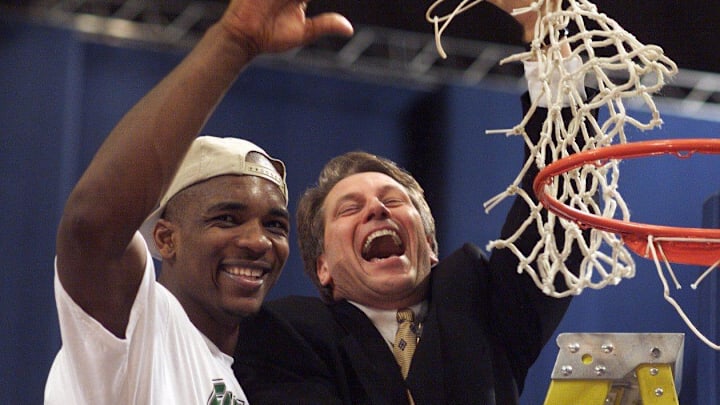 MSU's (13)ANTONIO SMITH and Coach TOM IZZO celebrate with the cut net after their their 73-66 win over Kentucky during their NCAA Midwest Regional Final game Sunday Mar 21, 1999 at the Trans World Dome in St. Louis, MO. MSU won the right to face Duke in the Final Four.(PHOTO BY KIRTHMON F. DOZIER/DETROIT FREE PRESS)