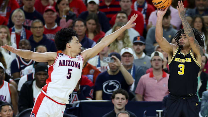 Apr 4, 2026; Indianapolis, IN, USA; Michigan Wolverines guard Elliot Cadeau (3) shoots over Arizona Wildcats guard Brayden Burries (5) in the first half during a semifinal of the Final Four of the men's 2026 NCAA Tournament at Lucas Oil Stadium. Mandatory Credit: Trevor Ruszkowski-Imagn Images Apr 4, 2026; Indianapolis, IN, USA; Michigan Wolverines guard Elliot Cadeau (3) shoots over Arizona Wildcats guard Brayden Burries (5) in the first half during a semifinal of the Final Four of the men's 2026 NCAA Tournament at Lucas Oil Stadium. Mandatory Credit: Trevor Ruszkowski-Imagn Images