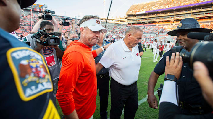 Auburn Tigers head coach Hugh Freeze congratulates Arkansas Razorbacks head coach Sam Pittman following Saturday's 24-14 loss.