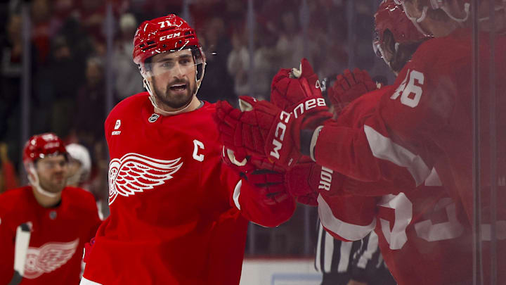 Oct 24, 2024; Detroit, Michigan, USA;  Detroit Red Wings center Dylan Larkin (71) receives congratulations from teammates after scoring in the third period against the New Jersey Devils at Little Caesars Arena. Mandatory Credit: Rick Osentoski-Imagn Images