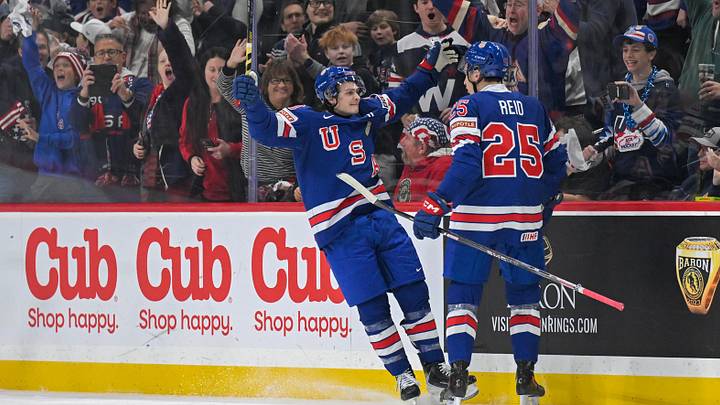 Dec 31, 2025; St. Paul, Minnesota, USA; USA defensemen Chase Reid (25) celebrates his power play goal against Sweden with forward James Hagens (10) during the second period in group play during the 2026 IIHF World Junior Championship at Grand Casino Arena. Mandatory Credit: Nick Wosika-Imagn Images