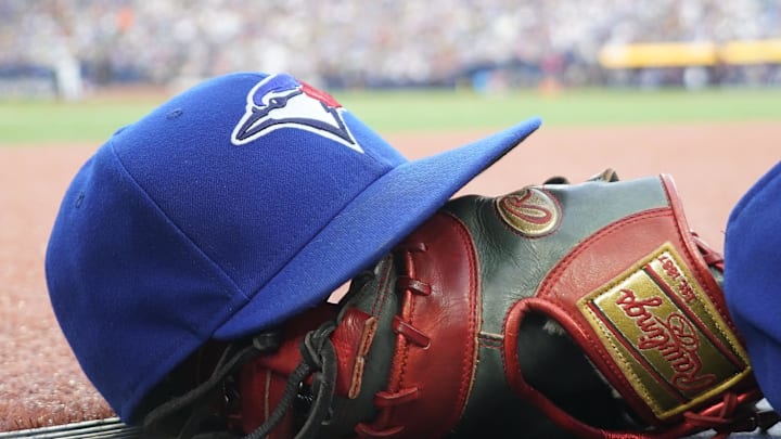 Jul 26, 2024; Toronto, Ontario, CAN; A Toronto Blue Jays hat and glove outside of the dugout during a game against the Texas Rangers at Rogers Centre. Mandatory Credit: John E. Sokolowski-Imagn Images
