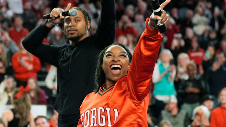 Simone Biles calls the Dawg with her husband Jonathan Owens during a NCAA gymnastics meet against Boise State in Athens, Ga., on Friday, Jan. 17, 2024. 