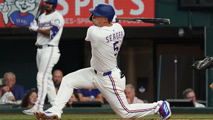Jul 26, 2025; Arlington, Texas, USA; Texas Rangers shortstop Corey Seager (5) follows through on a single during the third inning against the Atlanta Braves at Globe Life Field. 
