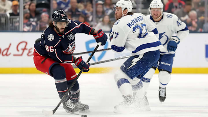 Blue Jackets forward Kirill Marchenko makes a move past Lightning defenseman Ryan McDonagh.