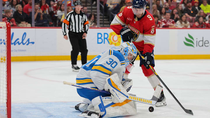 Dec 20, 2025; Sunrise, Florida, USA; St. Louis Blues goaltender Joel Hofer (30) makes a save against Florida Panthers center Sam Bennett (9) during the second period at Amerant Bank Arena. Mandatory Credit: Sam Navarro-Imagn Images