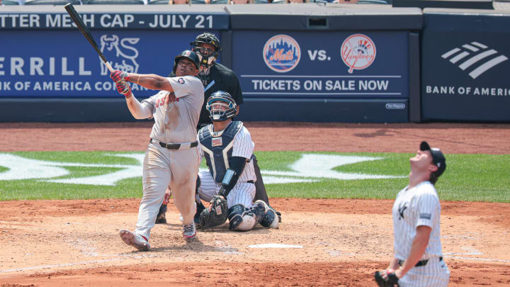 Jul 6, 2024; Bronx, New York, USA; Boston Red Sox third baseman Rafael Devers (11) hits a solo home run during the fifth inning against New York Yankees starting pitcher Gerrit Cole (45) at Yankee Stadium. Mandatory Credit: Vincent Carchietta-USA TODAY Sports