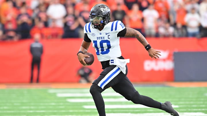 Sep 27, 2025; Syracuse, New York, USA; Duke Blue Devils quarterback Darian Mensah (10) runs out of the pocket in the second quarter against the Syracuse Orange. Sep 27, 2025; Syracuse, New York, USA; Duke Blue Devils quarterback Darian Mensah (10) runs out of the pocket in the second quarter against the Syracuse Orange.