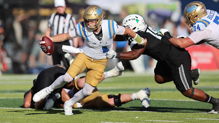 UCLA quarterback Ethan Garbers scrambles away from Hawaii's Dion Washington. Washington committed to Boise State on Friday. 