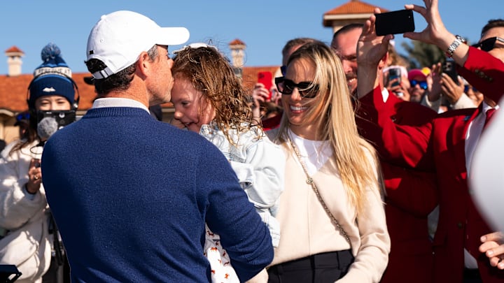 Rory McIlroy kisses his daughter Poppy, 5, on the forehead as his wife Erica Stoll, right, watches at TPC Sawgrass Monday March 17, 2025. Rory McIlroy kisses his daughter Poppy, 5, on the forehead as his wife Erica Stoll, right, watches at TPC Sawgrass Monday March 17, 2025.