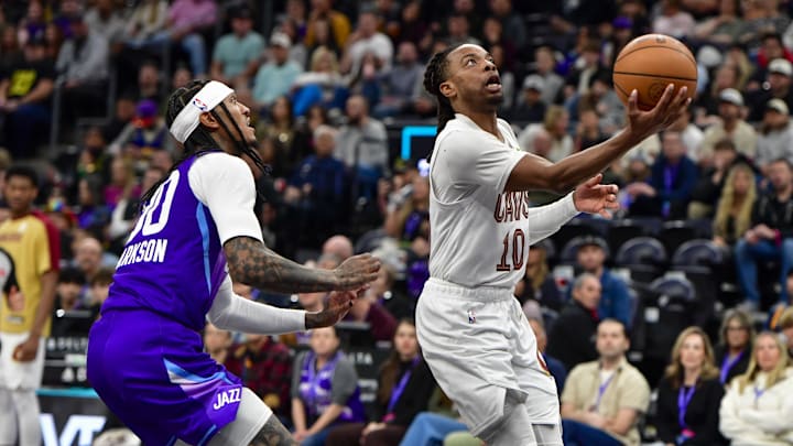Mar 23, 2025; Salt Lake City, Utah, USA; Cleveland Cavaliers guard Darius Garland (10) makes a layup against Utah Jazz guard Jordan Clarkson (00) during the second half at Delta Center. Mandatory Credit: Peter Creveling-Imagn Images