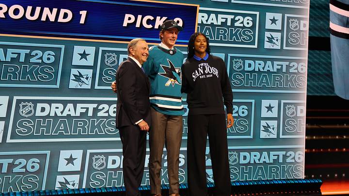 Jun 26, 2026; Buffalo, New York, USA; Keaton Verhoeff reacts beside NHL commissioner Gary Bettman and PWHL San Jose player Laila Edwards after being selected with the ninth pick in the first round of the 2026 NHL Draft by the San Jose Sharks at KeyBank Center. Mandatory Credit: Timothy T. Ludwig-Imagn Images