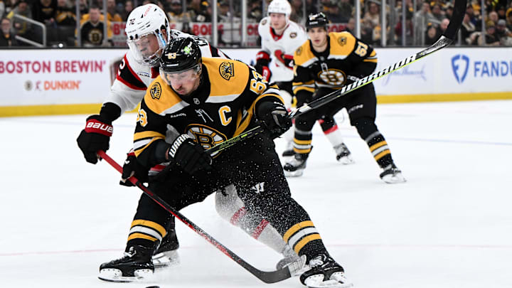 Jan 23, 2025; Boston, Massachusetts, USA; Ottawa Senators defenseman Thomas Chabot (72) defends Boston Bruins left wing Brad Marchand (63) during the third period at the TD Garden. Mandatory Credit: Brian Fluharty-Imagn Images
