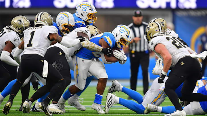 Oct 27, 2024; Inglewood, California, USA; Los Angeles Chargers running back J.K. Dobbins (27) runs the ball against the New Orleans Saints during the second half at SoFi Stadium. Mandatory Credit: Gary A. Vasquez-Imagn Images