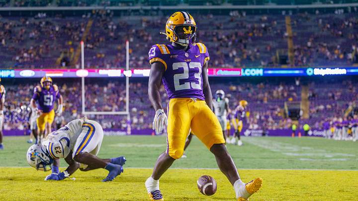 Oct 3, 2026; Baton Rouge, Louisiana, USA;  LSU Tigers running back Stacy Gage (23) rushes for a touchdown against McNeese Cowboys defensive end RJ Staten (23) during the second half at Tiger Stadium.  Mandatory Credit: Stephen Lew-Imagn Images