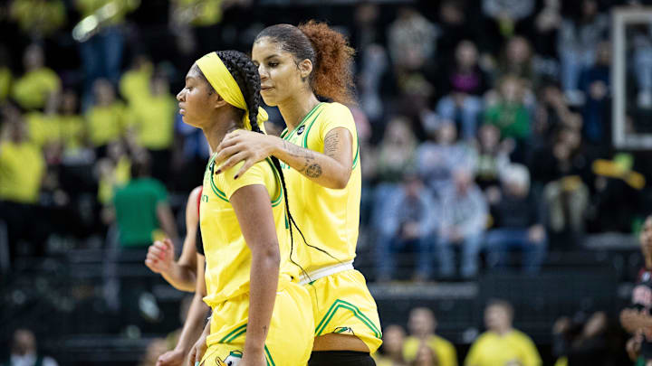 Oregon guards Priscilla Williams and Chance Gray walk on the court.