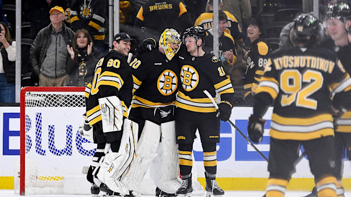 Feb 26, 2026; Boston, Massachusetts, USA; Boston Bruins goaltender Joonas Korpisalo (70) celebrates defeating the Columbus Blue Jackets with goaltender Michael DiPietro (80) and center Casey Mittelstadt (11) at TD Garden. Mandatory Credit: Eric Canha-Imagn Images