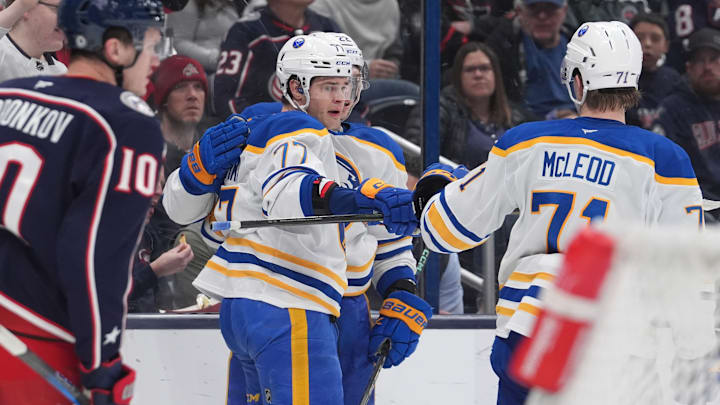JJ Peterka (77) celebrates his goal with a fistbump from Ryan McLeod (71) against the Columbus Blue Jackets. 