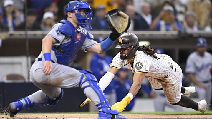 Jun 10, 2025; San Diego, California, USA; San Diego Padres right fielder Fernando Tatis Jr. (23) scores ahead of the throw to Los Angeles Dodgers catcher Dalton Rushing (68) during the third inning at Petco Park. Mandatory Credit: Denis Poroy-Imagn Images