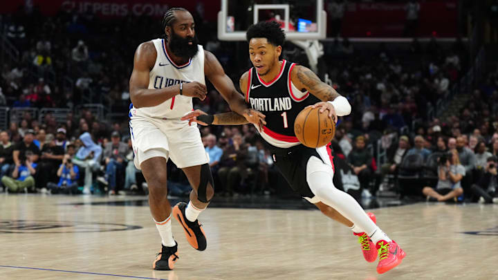 Dec 11, 2023; Los Angeles, California, USA; Portland Trail Blazers guard Anfernee Simons (right) dribbles the ball against LA Clippers guard James Harden in the second half at Crypto.com Arena. Mandatory Credit: Kirby Lee-Imagn Images