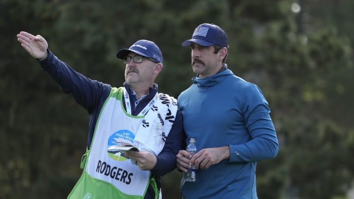 Feb 1, 2024; Pebble Beach, CA; New York Jets quarterback Aaron Rodgers (right) talks with his caddie on the 11th hole during the first round of the AT&T Pebble Beach Pro-Am golf tournament at Spyglass Hill Golf Course. 
