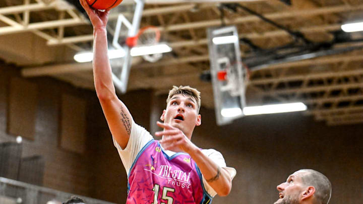 Team Tri-Star and Michigan State's Carson Cooper scores against Team SPS during the Moneyball Pro-Am on Thursday, June 26, 2025, at Holt High School. Team Tri-Star and Michigan State's Carson Cooper scores against Team SPS during the Moneyball Pro-Am on Thursday, June 26, 2025, at Holt High School.