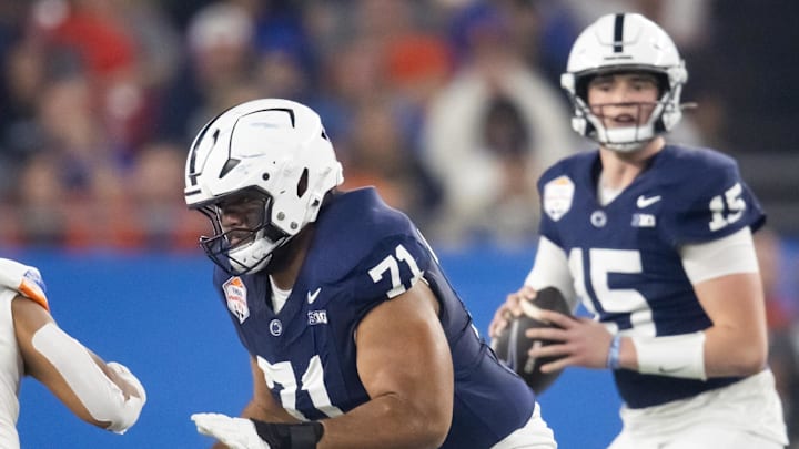 Dec 31, 2024; Glendale, AZ, USA; Penn State Nittany Lions offensive lineman Olaivavega Ioane (71) blocks for quarterback Drew Allar (15) against the Boise State Broncos in the Fiesta Bowl at State Farm Stadium. Mandatory Credit: Mark J. Rebilas-Imagn Images
