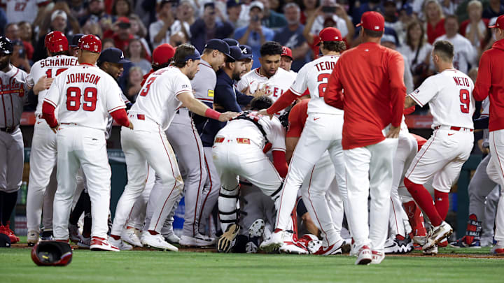 The Braves manager tackled his former player to ground as the benches cleared The Braves manager tackled his former player to ground as the benches cleared