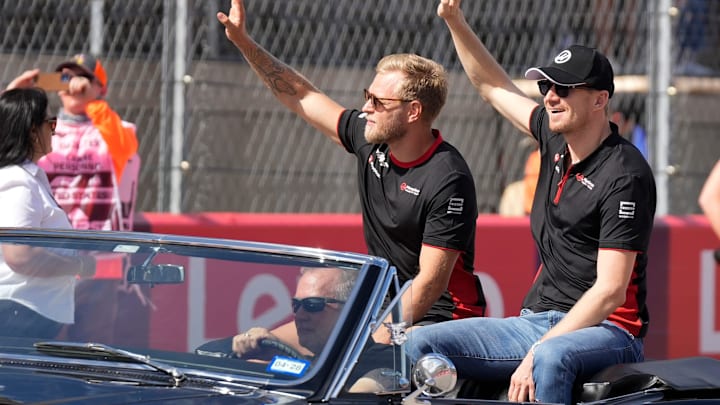 MoneyGram Haas drivers Kevin Magnussen of Denmark and Nico Hulkenberg of Germany wave to fans during