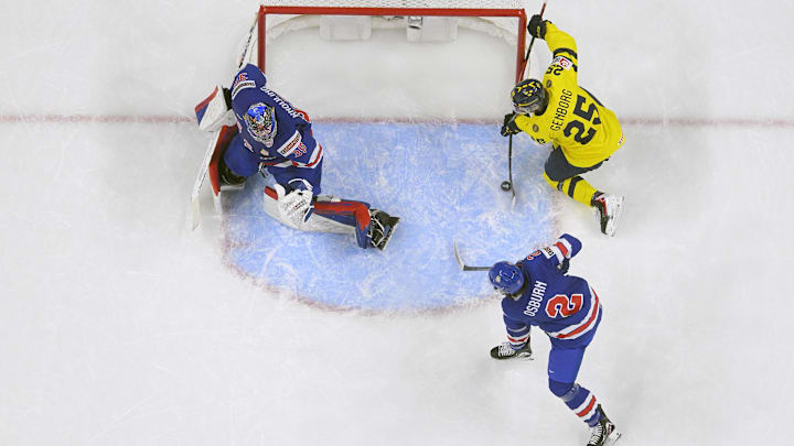Dec 31, 2025; St. Paul, Minnesota, USA; Sweden forward Eddie Genborg (25) scores a power play goal on USA goalie Brady Knowling (35) as defensemen Luke Osburn (2) closes in during the second period in group play during the 2026 IIHF World Junior Championship at Grand Casino Arena. Mandatory Credit: Nick Wosika-Imagn Images