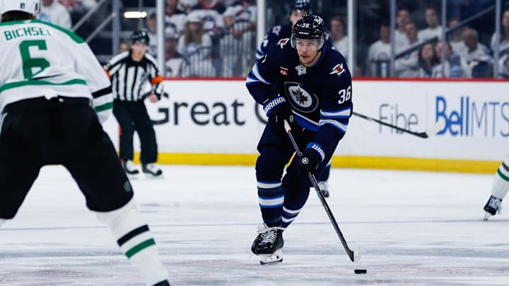 May 15, 2025; Winnipeg, Manitoba, CAN; Winnipeg Jets forward Morgan Barron (36) controls the puck against Dallas Stars defenseman Liam Bichsel (6) during the second period in game five of the second round of the 2025 Stanley Cup Playoffs at Canada Life Centre. Mandatory Credit: Terrence Lee-Imagn Images