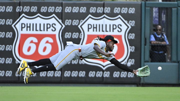 Pittsburgh Pirates center fielder Oneil Cruz (15) dives and catches a line drive hit by St. Louis Cardinals shortstop Masyn Winn (not pictured) during the first inning at Busch Stadium.