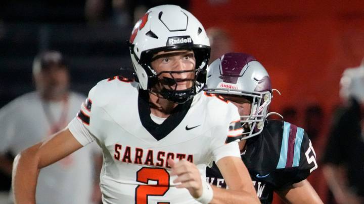Sarasota quarterback Hudson West (#2) scrambles as he looks for an open receiver, pursued by Riverview defensive lineman Jaxsun Blake (#50). The Riverview Rams hosted the Sarasota Sailors in a cross-town rivalry football game Friday evening, Sept. 26, 2025. Sarasota quarterback Hudson West (#2) scrambles as he looks for an open receiver, pursued by Riverview defensive lineman Jaxsun Blake (#50). The Riverview Rams hosted the Sarasota Sailors in a cross-town rivalry football game Friday evening, Sept. 26, 2025.