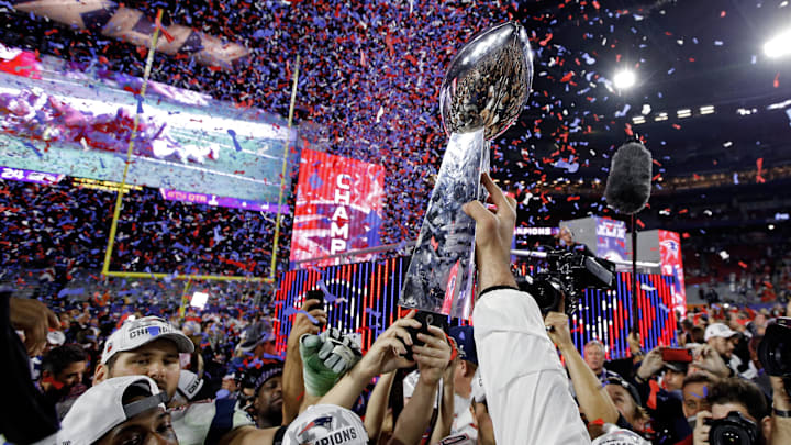 Feb 1, 2015; Glendale, AZ, USA; New England Patriots players celebrate with the Vince Lombardi Trophy after defeating the Seattle Seahawks in Super Bowl XLIX at University of Phoenix Stadium. Mandatory Credit: Mark J. Rebilas-Imagn Images