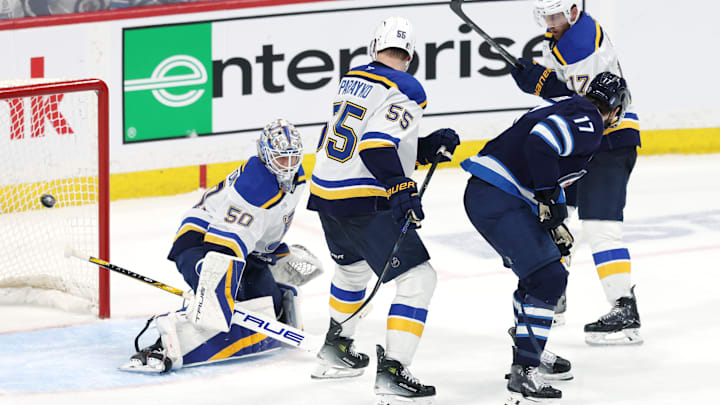 May 4, 2025; Winnipeg, Manitoba, CAN; Winnipeg Jets center Adam Lowry (17) scores a goal against St. Louis Blues goaltender Jordan Binnington (50) in the second overtime of game seven of the first round of the 2025 Stanley Cup Playoffs at Canada Life Centre. Mandatory Credit: James Carey Lauder-Imagn Images