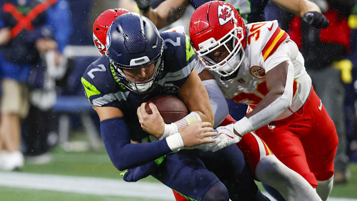 Aug 15, 2025; Seattle, Washington, USA; Kansas City Chiefs cornerback Christian Roland-Wallace (30) tackles Seattle Seahawks quarterback Drew Lock (2) during the second quarter at Lumen Field. Mandatory Credit: Joe Nicholson-Imagn Images