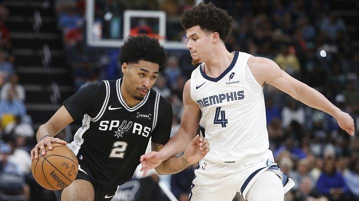 Mar 25, 2026; Memphis, Tennessee, USA; San Antonio Spurs guard Dylan Harper (2) drives to the basket as Memphis Grizzlies guard Walter Clayton Jr. (4) defends during the second quarter at FedExForum. Mandatory Credit: Petre Thomas-Imagn Images