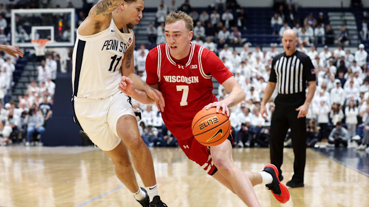 Jan 22, 2026; University Park, Pennsylvania, USA; Wisconsin Badgers guard Andrew Rohde (7) drives against Penn State Nittany Lions guard Eli Rice (11) during the first half at Rec Hall. Mandatory Credit: Matthew O'Haren-Imagn Images