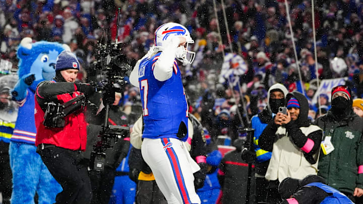 Jan 19, 2025; Orchard Park, New York, USA; Buffalo Bills quarterback Josh Allen (17) celebrates after scoring a touchdown against the Baltimore Ravens during the second quarter in a 2025 AFC divisional round game at Highmark Stadium.