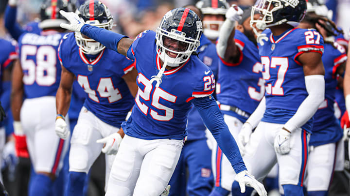 Oct 22, 2023; East Rutherford, New Jersey, USA; New York Giants cornerback Deonte Banks (25) celebrates after an interception against the Washington Commanders during the first half at MetLife Stadium. Mandatory Credit: Vincent Carchietta-USA TODAY Sports