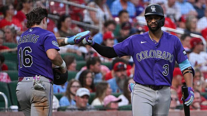 Colorado Rockies outfielder Cole Carrigg, congratulated by second baseman Willi Castro Colorado Rockies outfielder Cole Carrigg, congratulated by second baseman Willi Castro
