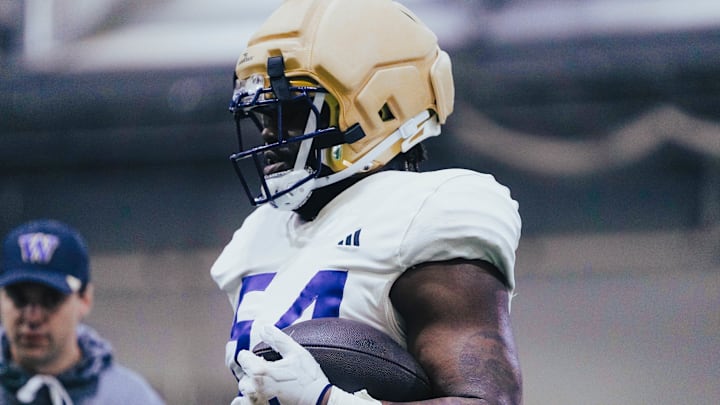 Anterio Thompson grips a football during spring ball. 