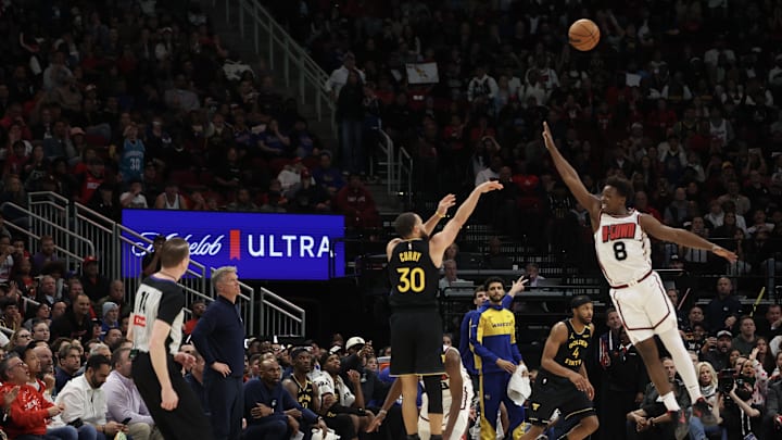 Golden State Warriors guard Stephen Curry (30) makes a three point basket against Houston Rockets forward Jae'Sean Tate (8) in the second  half at Toyota Center. Mandatory Credit: Thomas Shea-Imagn Images