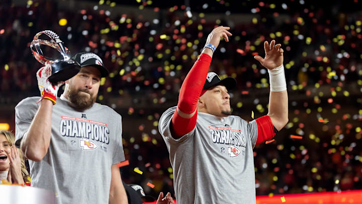 Jan 26, 2025; Kansas City, MO, USA; Confetti falls as Kansas City Chiefs tight end Travis Kelce (left) celebrates with the Lamar Hunt Trophy with quarterback Patrick Mahomes after defeating the Buffalo Bills during the AFC Championship game at GEHA Field at Arrowhead Stadium. Mandatory Credit: Mark J. Rebilas-Imagn Images