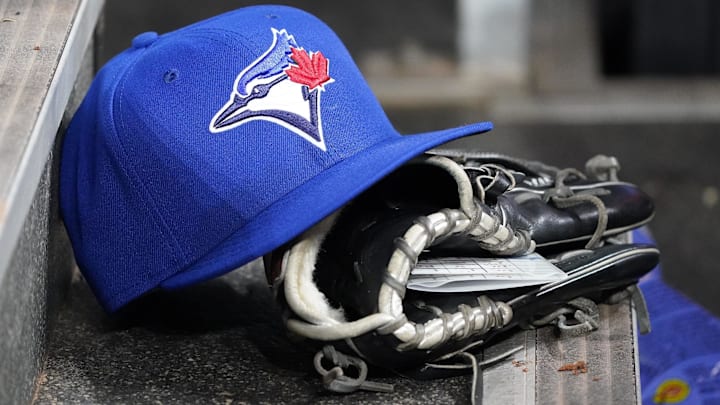 Apr 16, 2025; Toronto, Ontario, CAN; A Toronto Blue Jays hat and glove in the dugout during a game against the Atlanta Braves at Rogers Centre. 