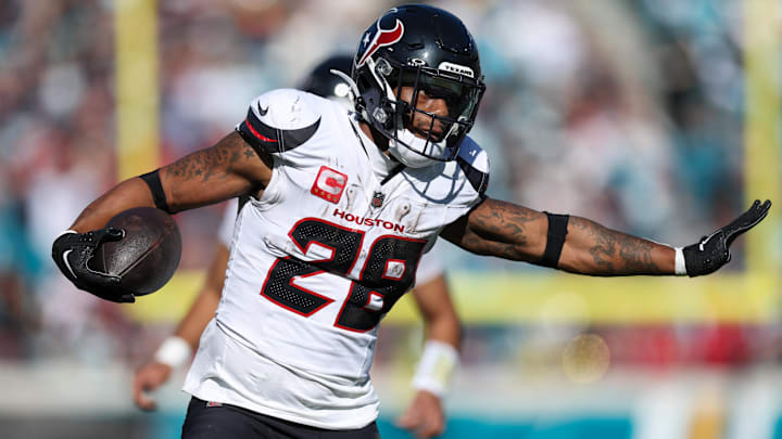 Dec 1, 2024; Jacksonville, Florida, USA; Houston Texans running back Joe Mixon (28) runs with the ball against the Jacksonville Jaguars in the second quarter at EverBank Stadium. 